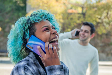 young people talking on the mobile phone in the street