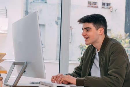 teenage boy working with computer at homeの写真素材
