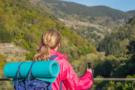 woman with backpack doing rural tourism on excursion