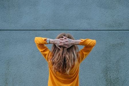 woman on her back with her hands on her headの写真素材