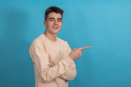 isolated teenager or student pointingの写真素材