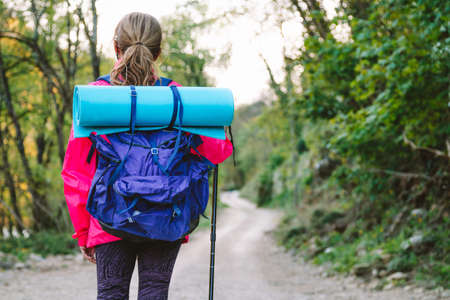 woman with backpack hiking or pilgrimage