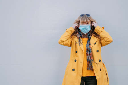 adult woman with mask on the streetの写真素材