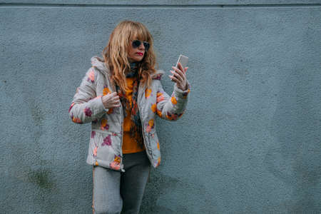 adult woman with mobile phone on the street