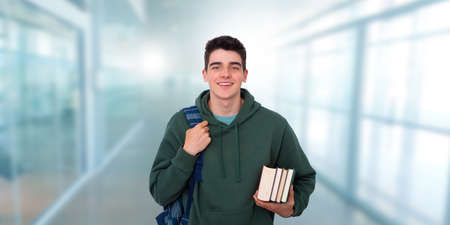 teenage student with books and backpack at college or universityの写真素材
