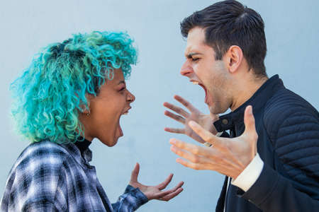 couple fighting or arguing furiously in the street