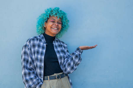 afro american woman on the wall pointing with handの写真素材