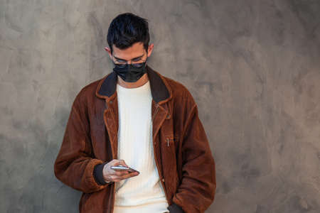 man with mask and mobile phoneの写真素材