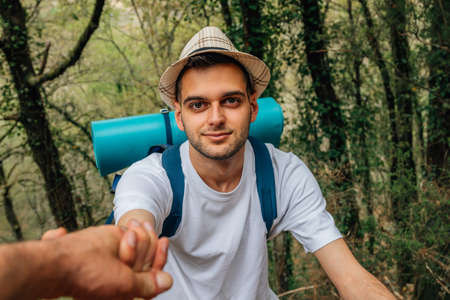 young people helping and collaborating practicing sports or hikingの写真素材