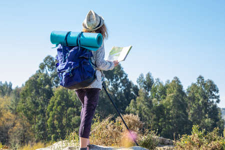 woman with backpack and map hikingの写真素材