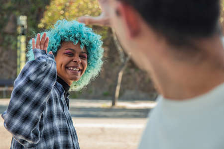 young couple greeting each other on the streetの写真素材