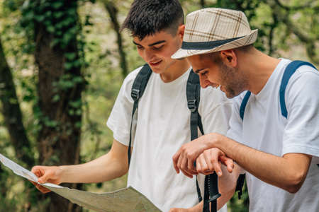 young people traveling with excursion or hiking mapの写真素材