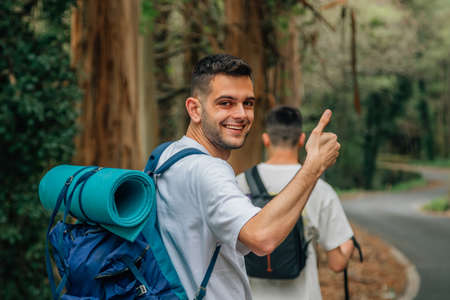 young man with okay sign happy practicing outdoor hiking sport in travel groupの写真素材