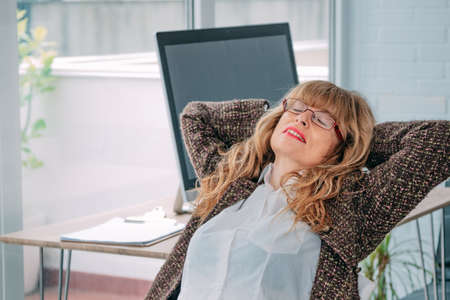 woman resting relaxed in the officeの写真素材