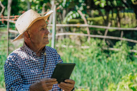 senior farmer with new technologies applied to the field and agricultureの写真素材