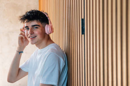 young man with headphones and mobile phone listening to musicの写真素材