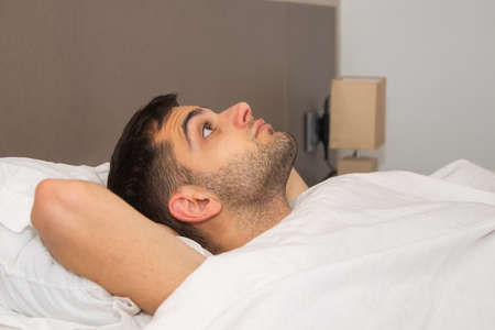 man in bed with insomnia