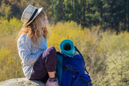 woman with a backpack hiking enjoying a relaxed hike