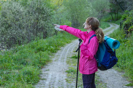 middle-aged woman with backpack while hiking or on pilgrimageの写真素材