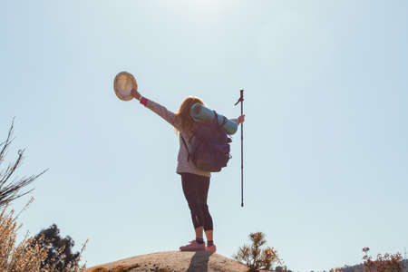 woman with backpack on mountain topの写真素材