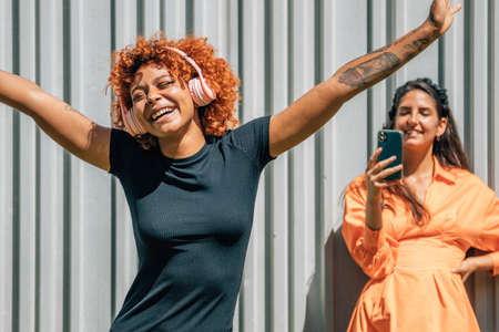 girls on the street dancing and singingの写真素材