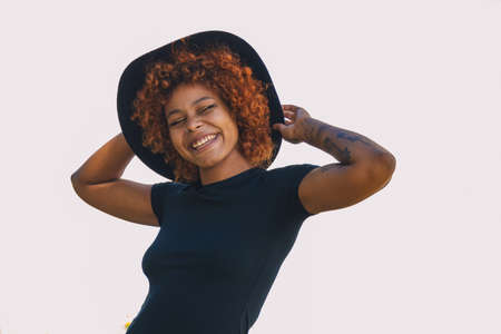 portrait of afro american girl with hat smiling isolated on white