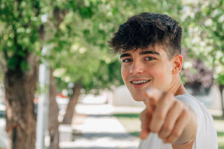 young teenager pointing at camera