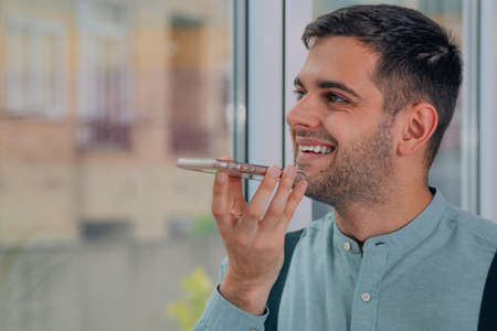 man sending a voice message on mobile phone
