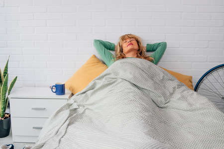woman at home sleeping in the bedroomの写真素材
