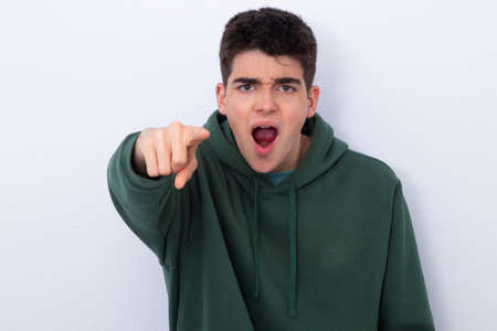isolated teenager with finger pointing accusing yellingの写真素材