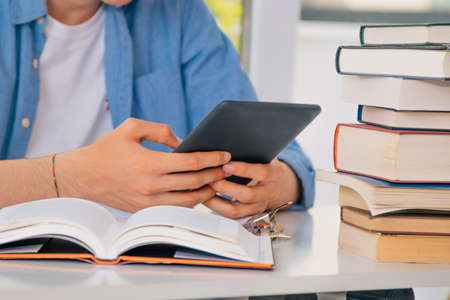 close-up of student hands using digital tablet or touch screenの写真素材