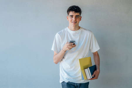 teenage student with books and mobile phoneの写真素材