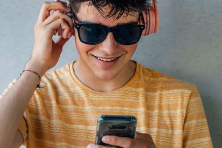 teenager with headphones and mobile phone