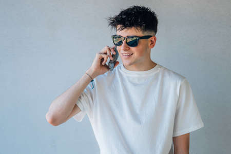 young teenager with sunglasses and mobile phone
