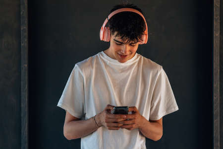 young teenager or student with headphones and mobile phoneの写真素材