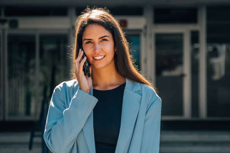 girl with mobile phone on the city street