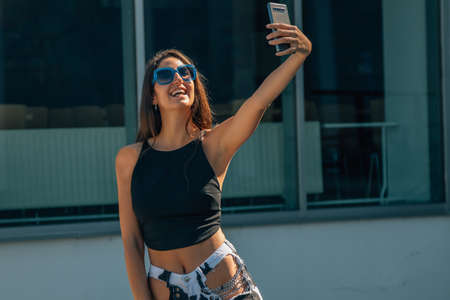 girl with mobile phone taking picture