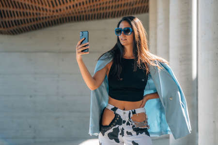 fashion girl with mobile phone and sunglassesの写真素材