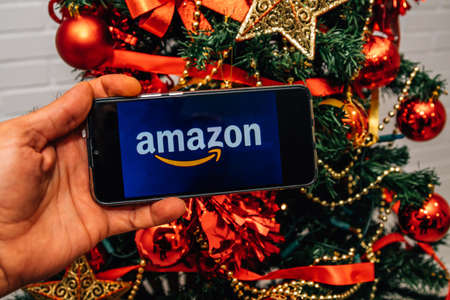 Galicia, Spain - November 24, 2021: mobile phone screen with amazon logo at christmasのeditorial素材