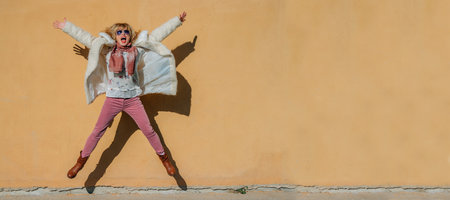 jumping woman isolated on the wallの写真素材