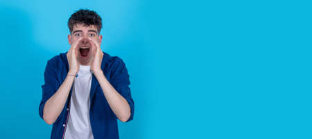 young teenager boy screaming isolated on backgroundの写真素材