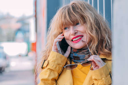 woman on the street talking on the mobile phoneの写真素材