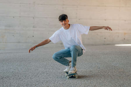 teenage boy skating with skateboardの写真素材