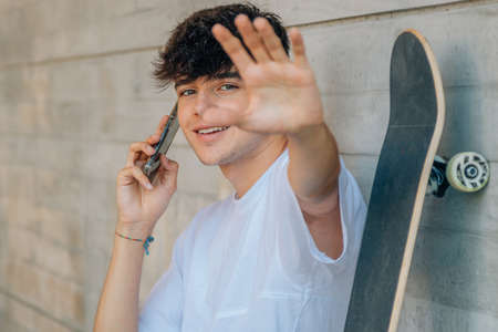 young teenager talking on the mobile phone in the street