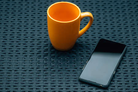 mobile phone with cup of coffee on the table