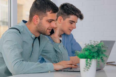 young teenagers or students with laptopの写真素材