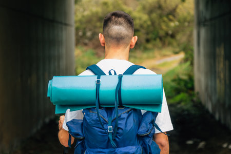man from his back with backpack hiking