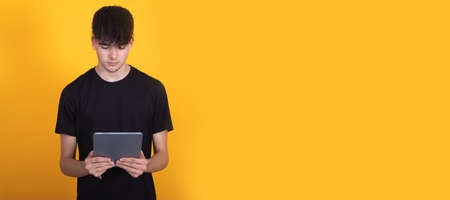 student with backpack isolated looking at tablet or deviceの写真素材