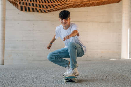 young man skating with skateboard in the cityの写真素材