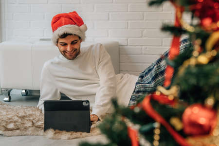 man at home at christmas with computer